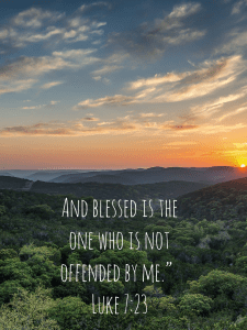 A picture of the sun peaking over the horizon. In green grass at the bottom are the words: And blessed is the one who is not offended by me. Luke 7:23. From a blog post at www.dawnmichellemichals.com 